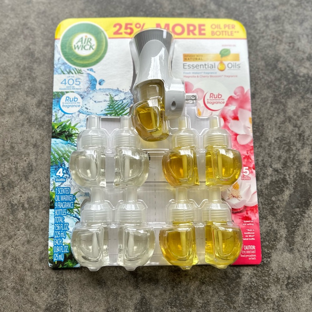 9 Air Wick Essential Oils Plug-In Refills and 1 Electric Warmer